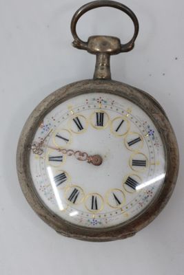 a silver pocket watch with roman numerals on it