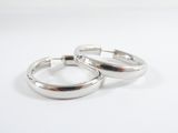 two silver rings on a white surface with a white background