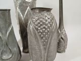 three vases sitting next to each other on a white surface