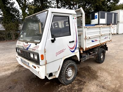 un camion blanc garé dans la poussière