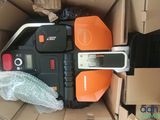 an orange and black remote control in a cardboard box