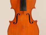 an old violin with a bow hanging from it ' s back