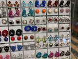 a lot of earrings on display in a display case