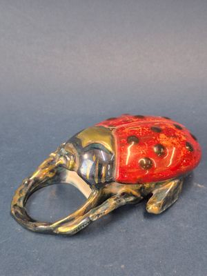 an elephant shaped ring with a ladybug on it ' s back