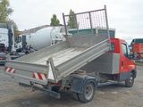 a red truck with a cement mixer in the back of it