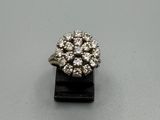 un gros plan d'une bague en diamant posée sur un socle noir