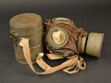 an old gas mask and a canister on a table
