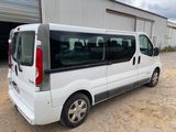 a small white van parked in front of a building