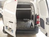 a white van with the back door open in a garage