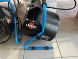 a black and blue blower sitting on the floor next to a blue hose