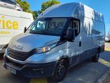 une camionnette argentée garée sur un parking à côté d'un bus