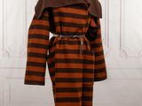 a brown and black striped coat on a mannequin stand