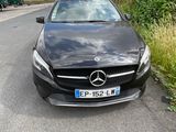 the mercedes cla is parked on the side of the road