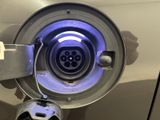 a close up of a car ' s front door with a blue light
