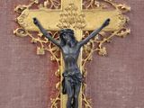 a statue of jesus on the cross on the wall