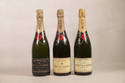 three bottles of champagne sitting next to each other on a table