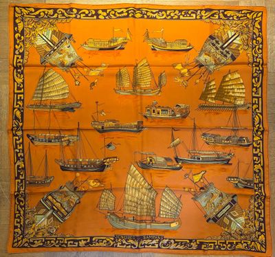 an orange silk scarf with boats and ships on it