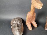 three wooden sculptures of different shapes and sizes on a black surface