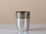 a silver cup that is sitting on a table