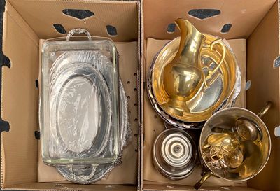 a cardboard box with some gold items inside of it