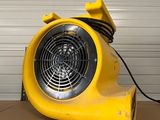 a yellow blower sitting on top of a brown table