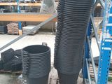 a stack of black plastic cups sitting on a pallet in a warehouse