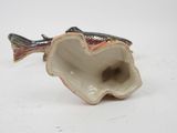 porcelain figurine of a fish in a shell on a white surface