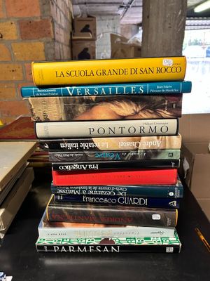 many books stacked on top of each other on a table