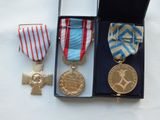 three medals and a medal in a box on a table