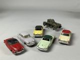 several toy cars are lined up in a circle on a white surface