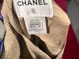 chanel label on a chanel jacket on a person ' s hand