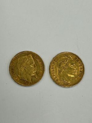 two pieces of gold coins on a white surface