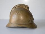 a gold helmet sitting on a white surface