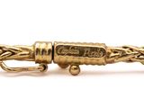 a close up of a gold bracelet with a clasp on a white background