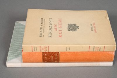 two books stacked on top of each other on a table