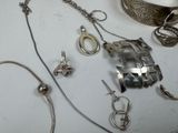 a table with a bunch of silver jewelry on it