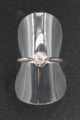 a close up of a ring with a diamond on it
