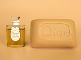 soap and soap bar on a table with a bottle of dios
