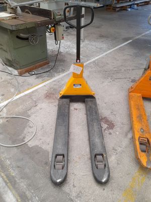 a forklift sitting on the ground in a warehouse