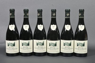six bottles of wine are lined up in a row on a table