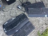 a lot of keyboards and a computer on the ground
