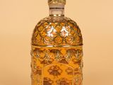 an image of a glass bottle with a decorative design on it