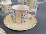 a tea set with a tea pot and a cup on a table