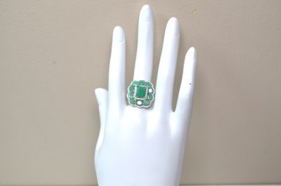 a hand with a ring on it that is on a mannequin