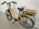 a yellow bicycle with a basket on the back of it