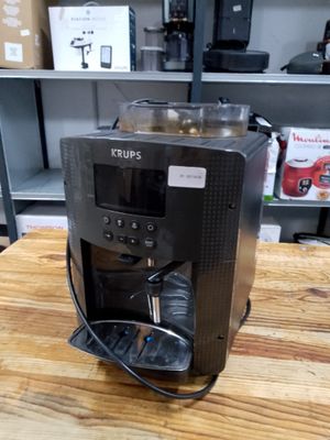 a coffee maker sitting on a wooden table in a store