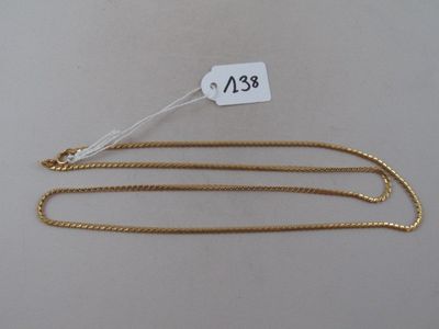 a close up of a gold chain with a price tag on it