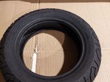 a close up of a tire sitting on top of a cardboard box