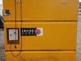 a close up of a yellow tool box sitting on top of a dirt field