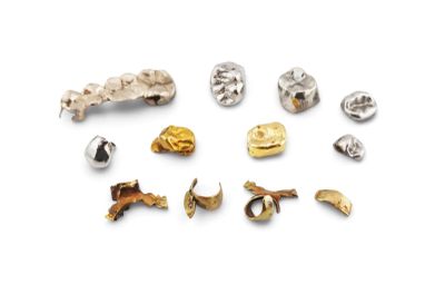 many different types of metal buttons on a white surface